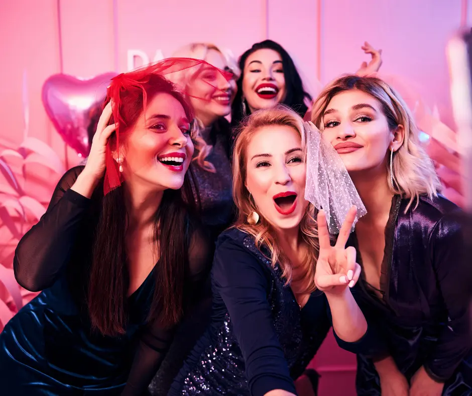 Eine Gruppe von Frauen auf ihrem JGA lachen in Kamera